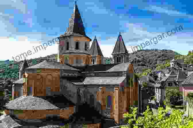 Exterior View Of The Abbey Church Of St. Foy At Conques, Showcasing Its Romanesque Architecture And Intricate Carvings The Abbey Church Of St Foy At Conques: An Esoteric Perspective